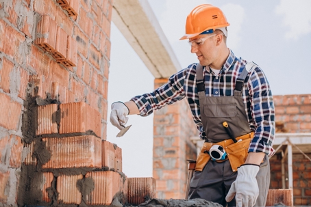 construction worker laying brick